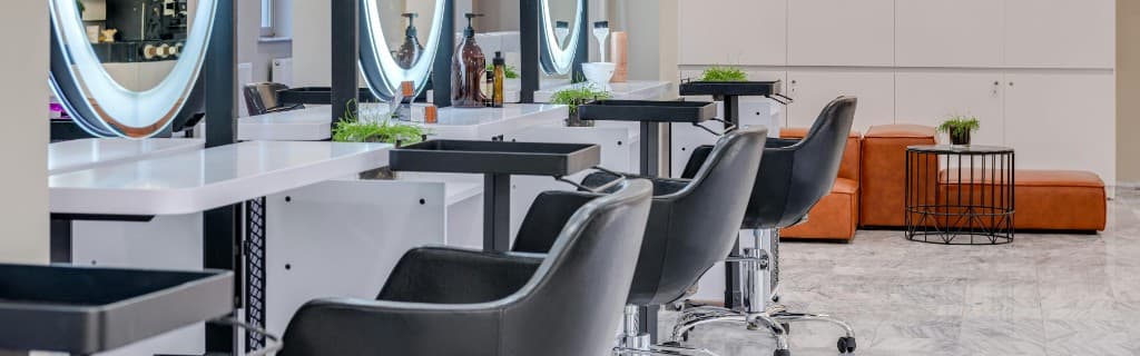 Barbers serving clients in a busy salon